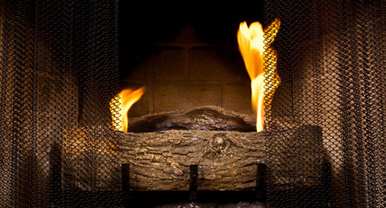 Lit fireplace with Condar hanging screen